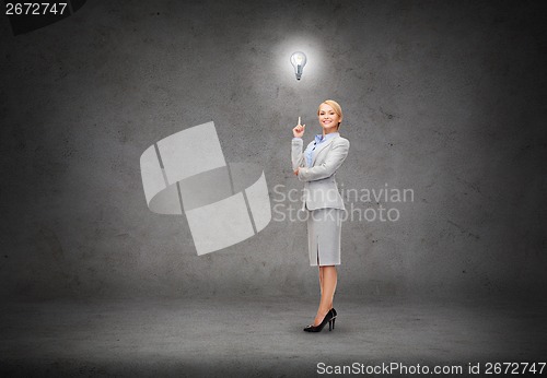 Image of attractive young businesswoman with her finger up