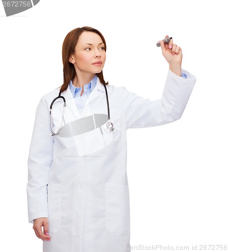 Image of young female doctor writing something in the air