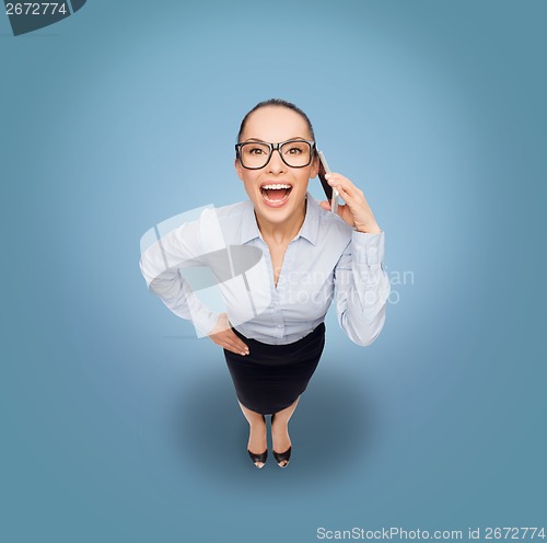 Image of happy businesswoman in eyeglasses with smartphone