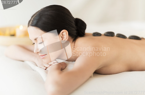 Image of woman in spa with hot stones