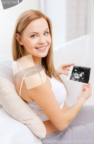 Image of happy pregnant woman with ultrasound picture