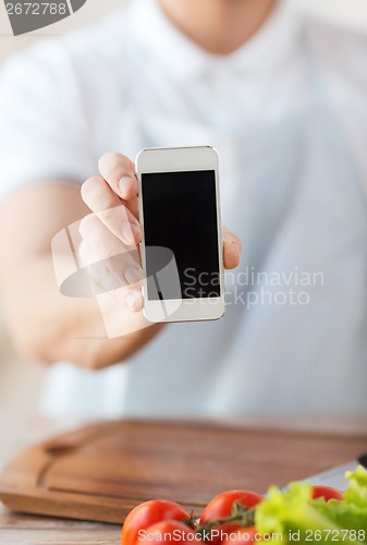 Image of close up of male hands holding smartphone