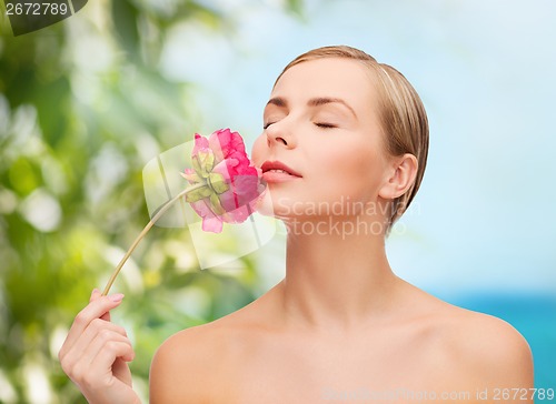 Image of lovely woman with peonie flower