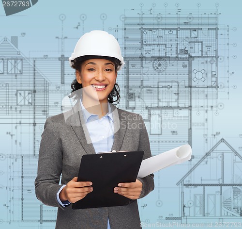 Image of businesswoman in white helmet with clipboard