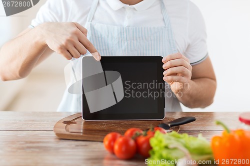 Image of close up of male hands holding tablet pc