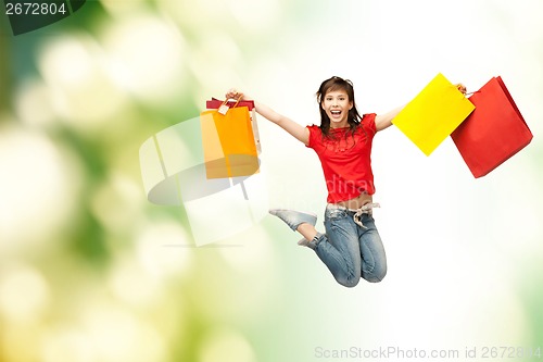 Image of excited girl with shopping bags