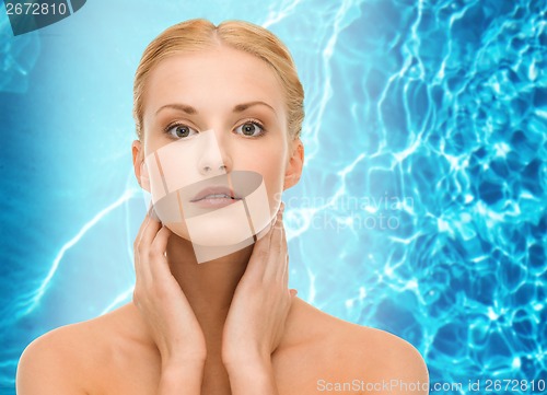 Image of beautiful woman touching her face skin