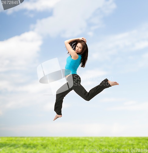 Image of sporty woman jumping in sportswear