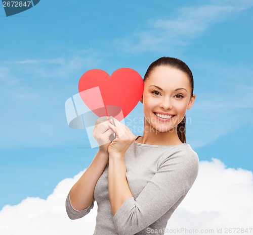 Image of smiling asian woman with red heart