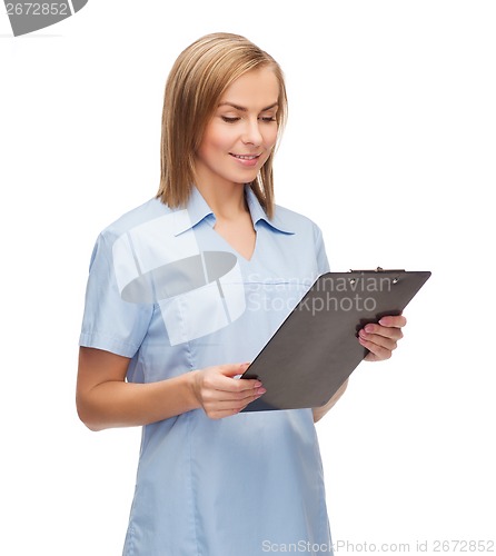 Image of smiling female doctor or nurse with clipboard