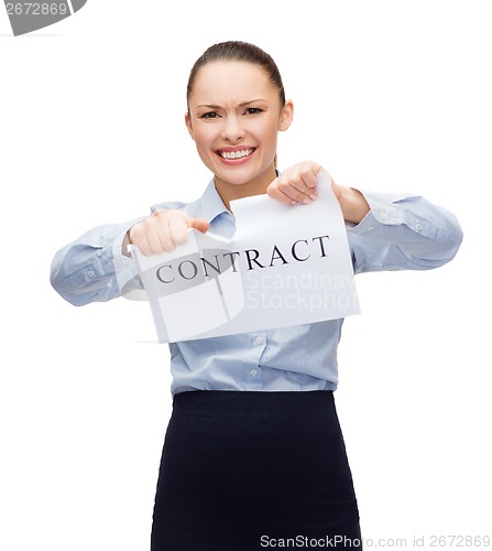 Image of serious businesswoman tearing contract