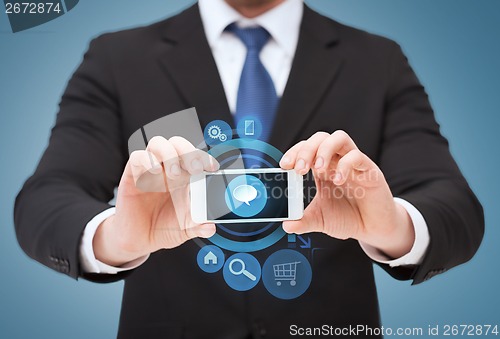 Image of businessman showing smartphone with blank screen