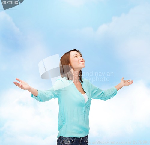 Image of smiling woman waving hands