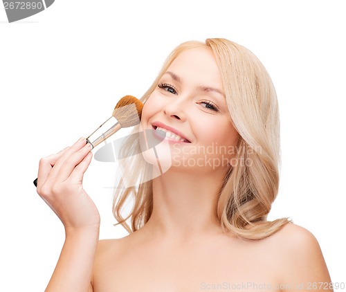 Image of beautiful woman with closed eyes and makeup brush