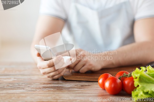 Image of closeup of man pointing finger to smartphone