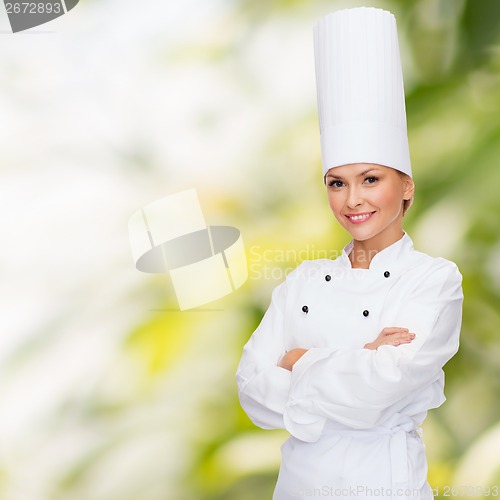 Image of smiling female chef with crossed arms