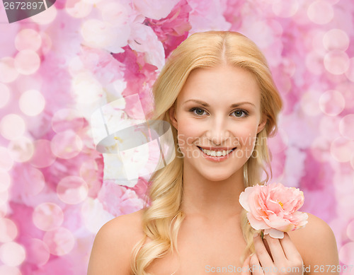 Image of smiling woman with peony flower