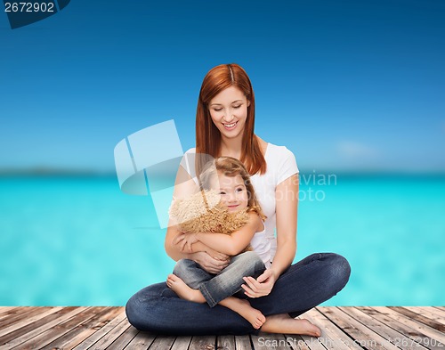 Image of happy mother with adorable girl and teddy bear