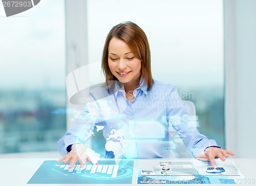 Image of woman pointing to buttons on virtual screen