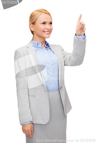 Image of smiling businesswoman working with virtual screen