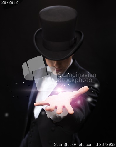 Image of magician holding something on palm of his hand