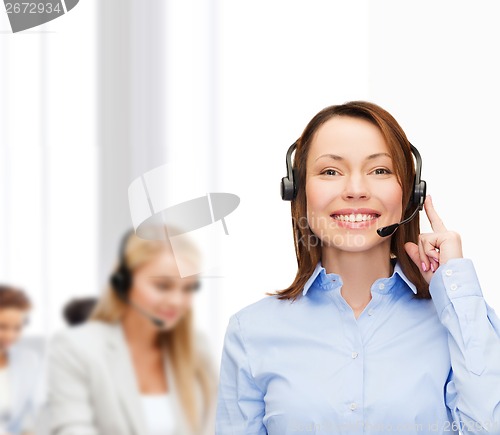 Image of friendly female helpline operator at office