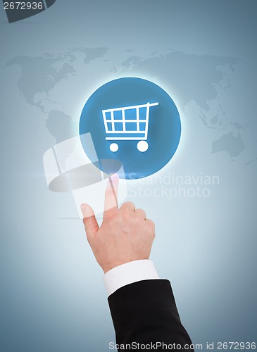 Image of close up of businessman pointing to shopping cart