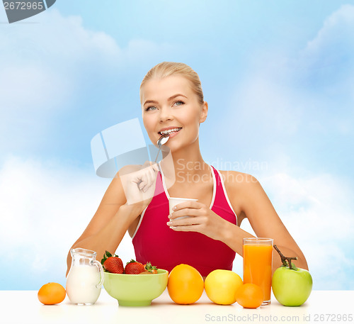 Image of young woman eating healthy breakfast