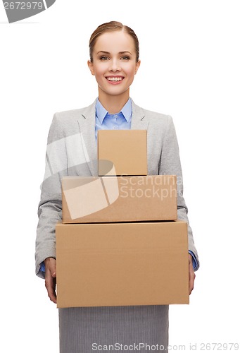 Image of smiling businesswoman holding cardboard boxes