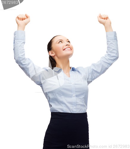 Image of smiling businesswoman with hands up
