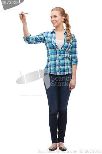 Image of smiling young woman writing on virtual screen