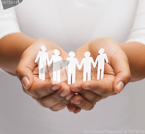 Image of womans hands with paper team