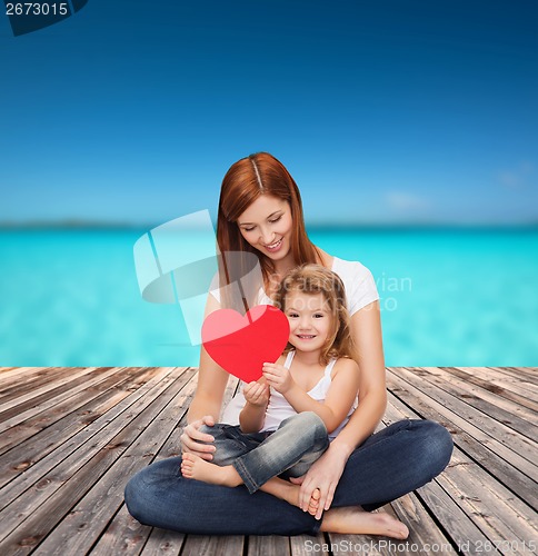 Image of happy mother with adorable little girl and heart