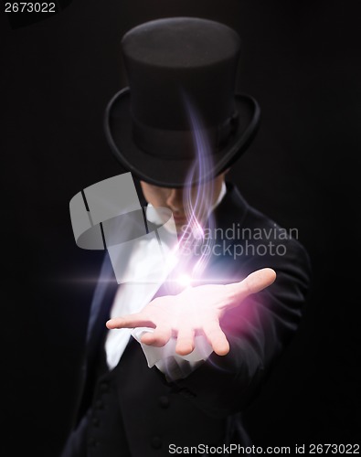 Image of magician holding something on palm of his hand