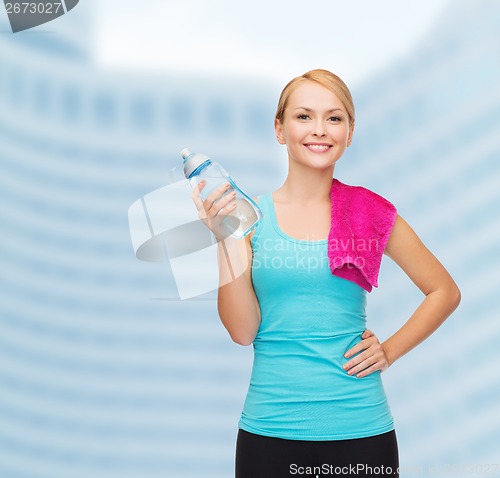 Image of sporty woman with towel and watel bottle