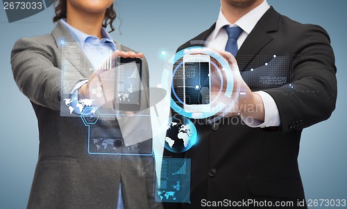 Image of businessman and businesswoman with smartphones