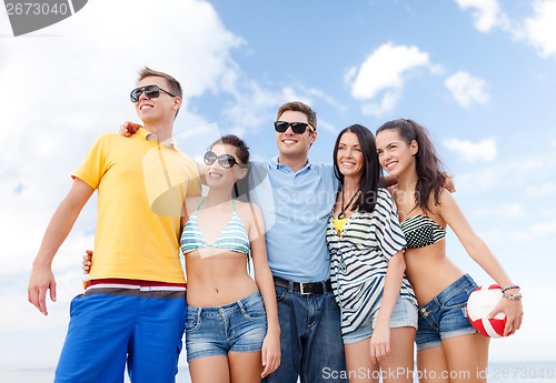 Image of group of friends having fun on the beach