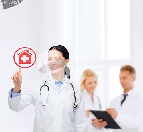 Image of smiling female doctor pointing to something