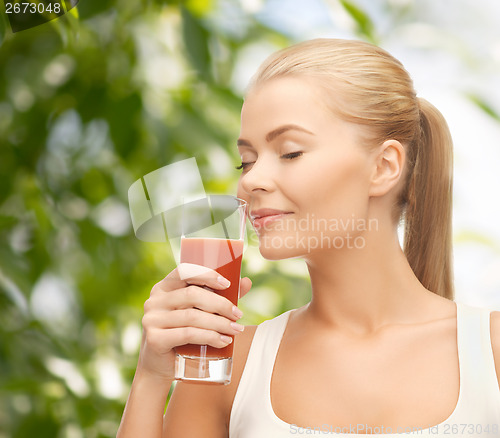 Image of young woman drinking tomato juice