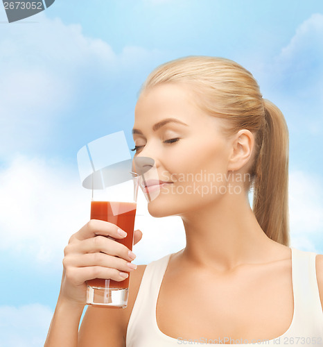 Image of young woman drinking tomato juice