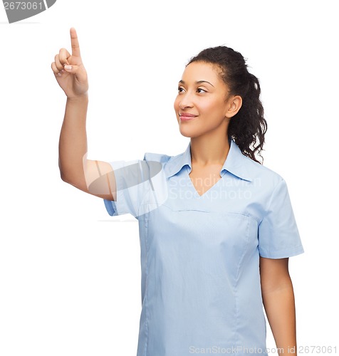 Image of smiling doctor or nurse pointing to something