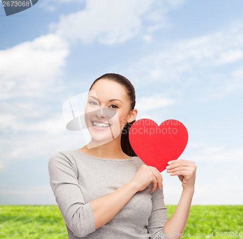 Image of smiling asian woman with red heart