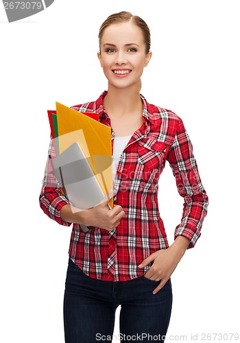 Image of smiling student with folders and tablet pc