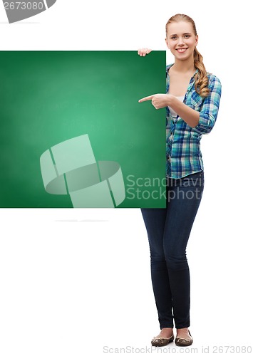 Image of smiling young woman with green blank board