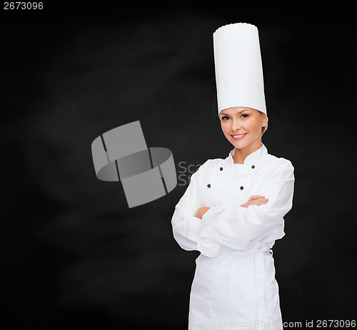 Image of smiling female chef with crossed arms