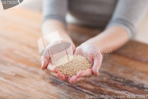 Image of cloes uo of female cupped hands with quinoa