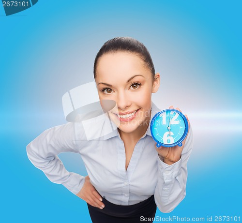 Image of smiling businesswoman with blue clock