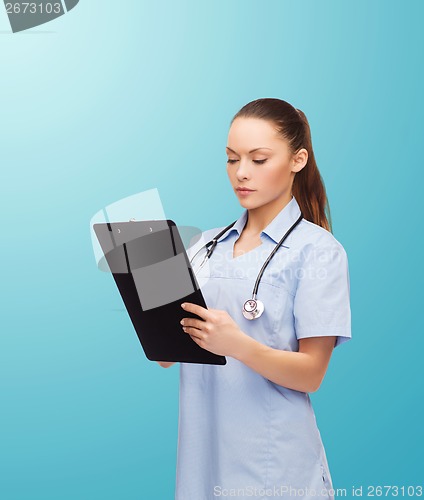 Image of serious female doctor or nurse with stethoscope