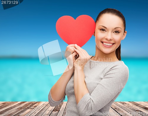 Image of smiling asian woman with red heart