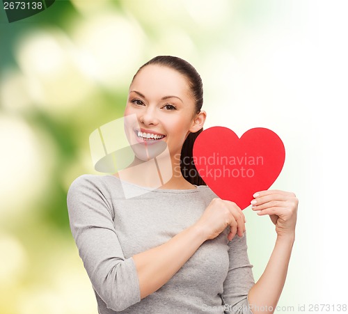 Image of smiling asian woman with red heart